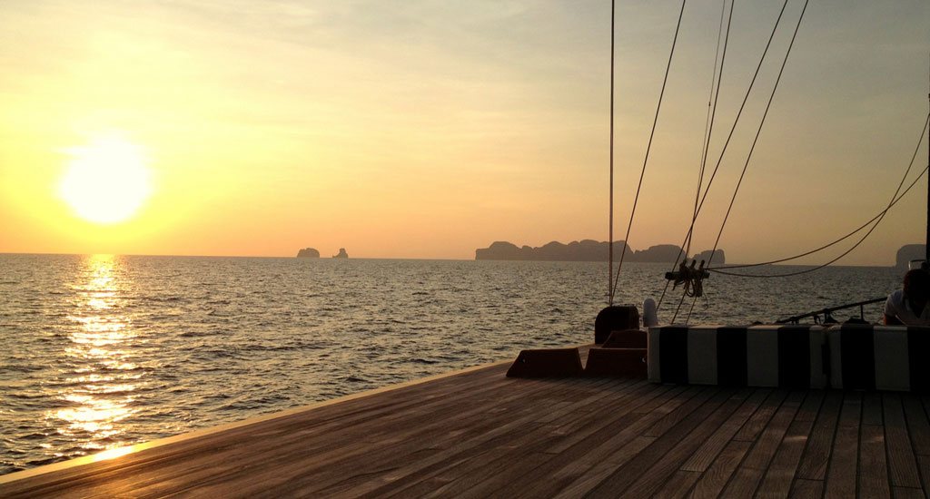 Beautiful warm sunset in Southeast Asia in front of the ocean from a pier