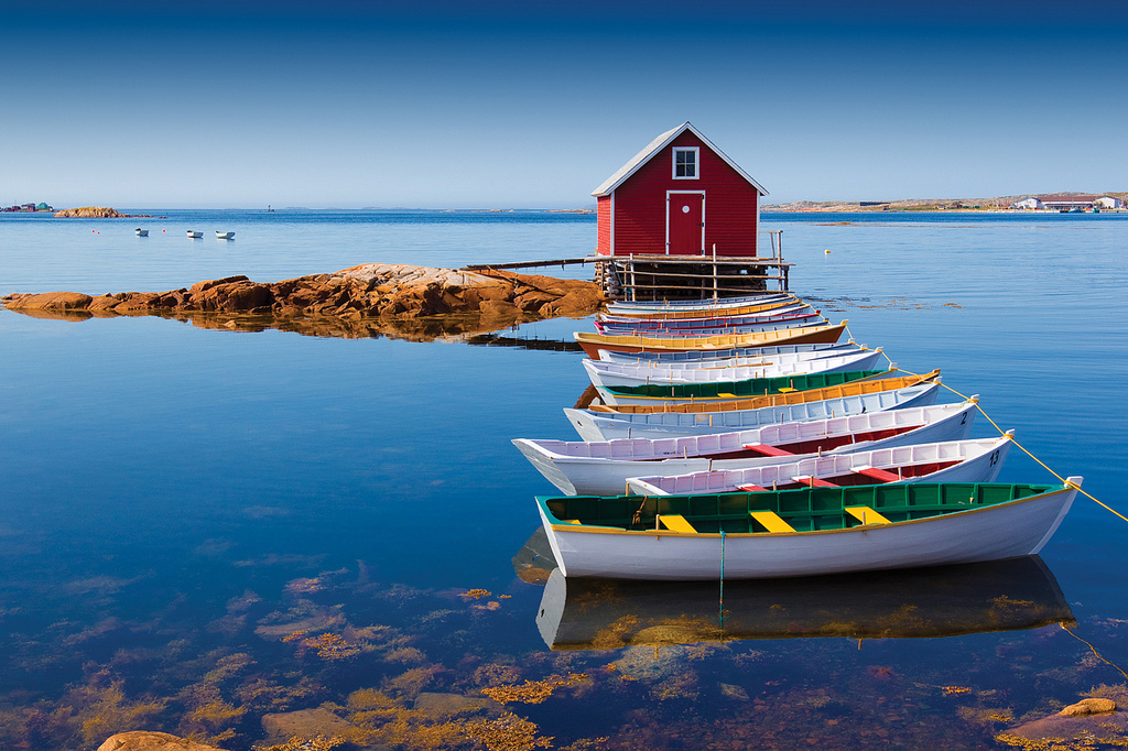 Peaceful lake with colourful boats and a nice little hut your retreat for travel as therapy