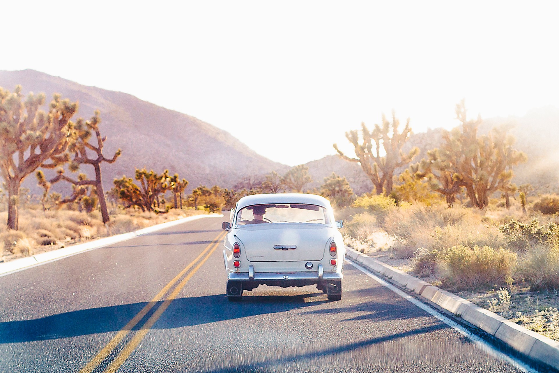 Solo travel roadtrip california empty road vintage car sun and freedom truly bespoke