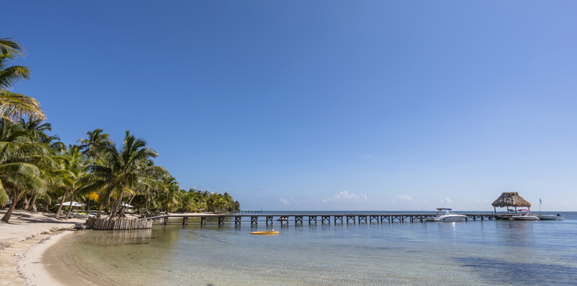 Caribbean sandy beach pier with boats