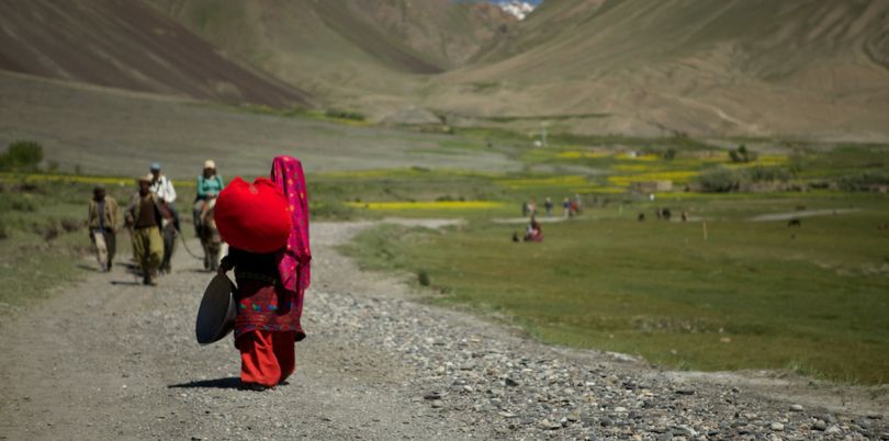 Woman walking away in the Wakhan Corridor, in Afghanistan