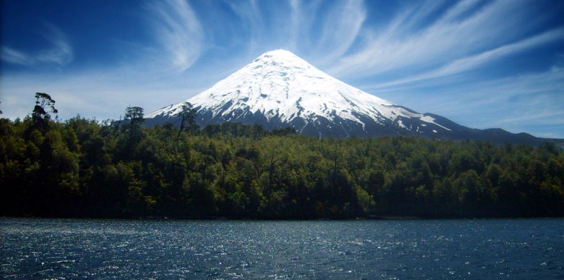 Osorno volcano with snowy peak view across lake in Chile