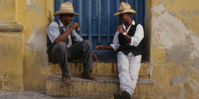 Two Cuban men chatting in a doorway