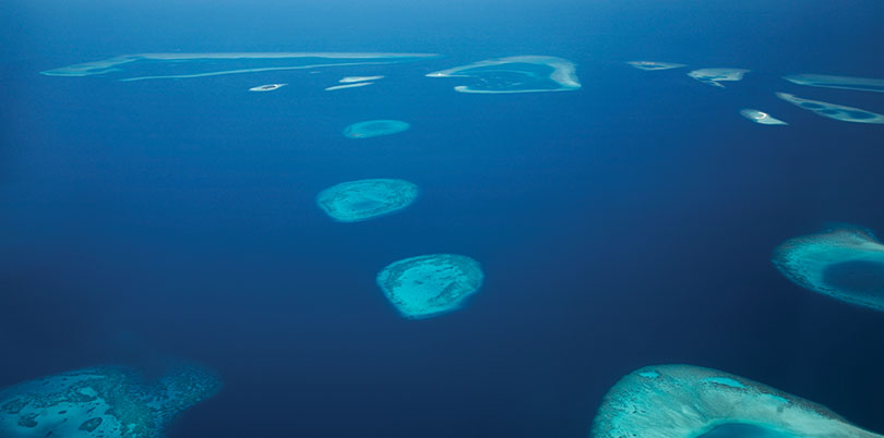 View down on Maldive islands from plane discover the Indian Ocean 