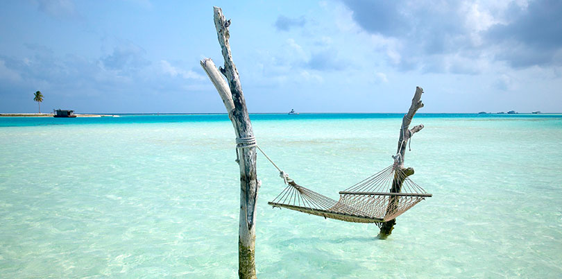 Maldives hammock in the ocean crystal clear water