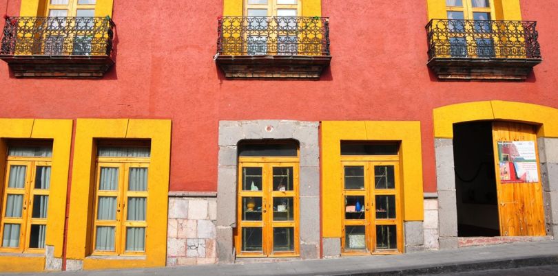 Street view of orange and yellow buildings, Mexico