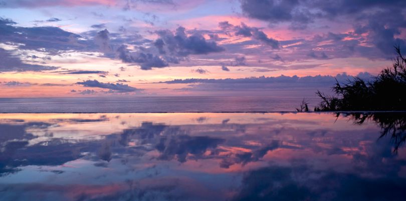 Sunset over an infinity pool in Imanta Resort, Mexico