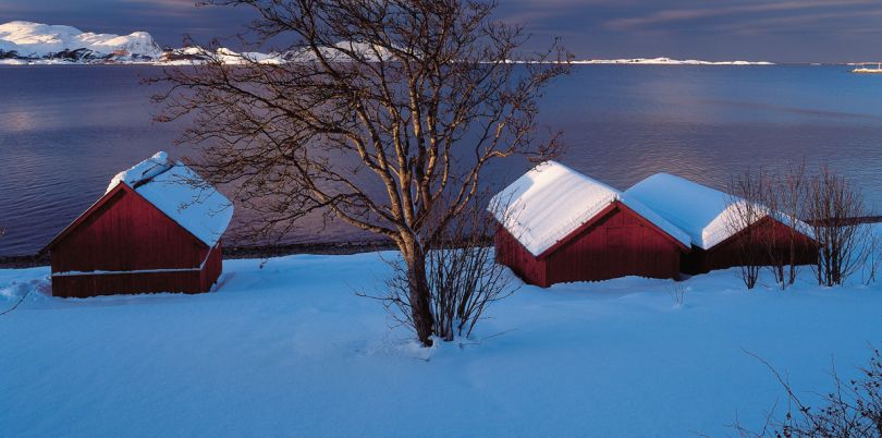 Houses overlooking the sea in the snow, Norway