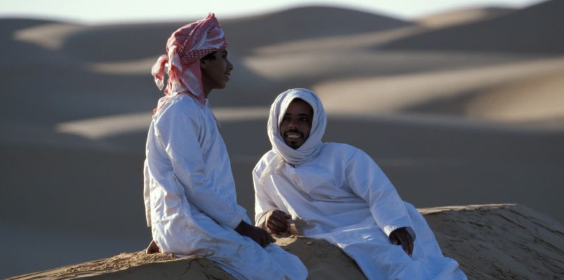 Two local men sitting on the dunes, Oman