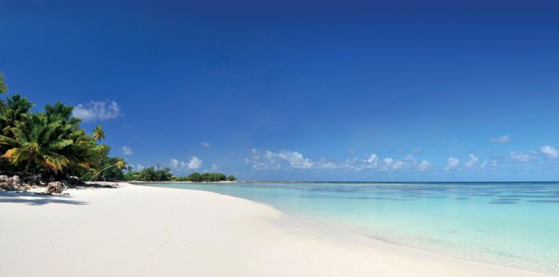 Beach on Desroches Island in the Seychelles crystal clear water endless white sand